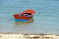 Red wooden fishing boat moored on the shore Royalty Free Stock Photo