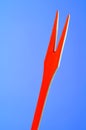 Red Wooden Fork on Blue Background