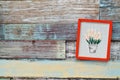 Red wooden frame hanging on a wooden board Royalty Free Stock Photo