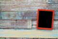 Red wooden frame hanging on a wooden board Royalty Free Stock Photo