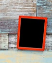 Red wooden frame hanging on a wooden board Royalty Free Stock Photo