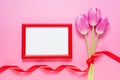 Red wooden frame, tulips and red satin ribbon