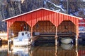 Red wooden garage for three boats Royalty Free Stock Photo