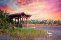 Red wooden gazebo by the pond Royalty Free Stock Photo