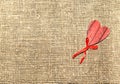 Red wooden heart isolated over burlap Royalty Free Stock Photo