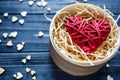 Red wooden heart lies in box on dark table with mini hearts around. St Valentines , Mothers day, romance concept Royalty Free Stock Photo