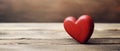 Red wooden heart on an old brown wooden table, on a dark blurred background. Valentine day concept for design. Symbol of love. Royalty Free Stock Photo