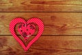 Red wooden heart placed on a brown wood board