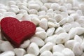 Red wooden heart on a white pebble background. Royalty Free Stock Photo