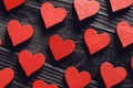 Red wooden hearts on black wooden background