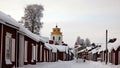 Red wooden historic church houses of Gammelstad near Lulea in winter in Sweden