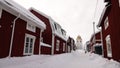 Red wooden historic church houses of Gammelstad near Lulea in winter in Sweden