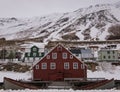 Red wooden house in front of snow covered mountain Royalty Free Stock Photo
