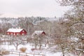 red wooden houses in snow garden in Sweden. House is traditional Swedish color Royalty Free Stock Photo