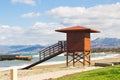 Red wooden lifeguard hut on an empty morning beach Royalty Free Stock Photo