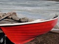 Red wooden motorboat on a frozen lake