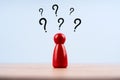 red wooden pawn with some question marks on white background Royalty Free Stock Photo