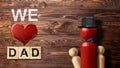 Red wooden peg doll with a black hat and bow tie with a red heart and We Love Dad text