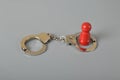 Red wooden people of figure with handcuff locked. Handcuffed convict, law offender and justice concept