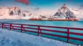 Red wooden pier on Gravdal bay. Frosty winter scene of popular tourist destination - Lofoten Islands