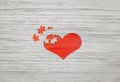 Red wooden puzzle heart on grey background Royalty Free Stock Photo