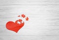 Red wooden puzzle heart on grey background Royalty Free Stock Photo