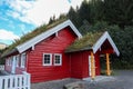 Red wooden scandinavian grass roof house in Norway Royalty Free Stock Photo