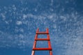 Red Staircase Rests Against Blue Sky. Development motivation Career Growth Concept Royalty Free Stock Photo