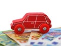 red wooden toy car on euro money banknotes isolated on white background with copy space Royalty Free Stock Photo