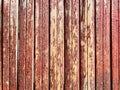 Old wooden fence with peeling red paint background Royalty Free Stock Photo