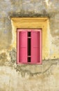 Red wooden window on yellow wall Royalty Free Stock Photo