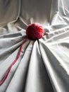 Red wool ball with grey fabric