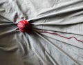 Red wool ball with grey fabric