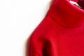 Red wool sweater hanging on clothes hanger on white background.close up Royalty Free Stock Photo