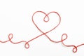 Red woolen thread in the shape of heart on white background Royalty Free Stock Photo