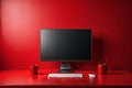 Red workspace, computer screen, keyboard, mouse, mugs. Background red wall. Use website, blog, ad Royalty Free Stock Photo