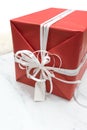 Red wrapped present box with white fancy bow tie and blank greet Royalty Free Stock Photo