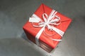 Red wrapped present box with white fancy bow tie and blank greet Royalty Free Stock Photo