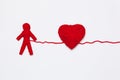 Red yarn heart and human figure