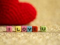 Red yarn heart with I Love You text from bead colorful on the gold floor and background copy space for text. Valentines day, love Royalty Free Stock Photo