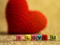 Red yarn heart with I Love You text from bead colorful on the gold floor and background copy space for text. Valentines day, love Royalty Free Stock Photo
