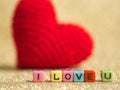 Red yarn heart with I Love You text from bead colorful on the gold floor and background copy space for text. Valentines day, love Royalty Free Stock Photo