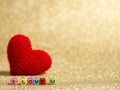 Red yarn heart with I Love You text from bead colorful on the gold floor and background copy space for text. Valentines day, love Royalty Free Stock Photo