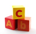 Red and yellow alphabet wooden blocks isolated on the white background Royalty Free Stock Photo