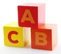 Red and yellow alphabet wooden blocks on the white background Royalty Free Stock Photo