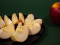 Red yellow apple and slice isolated on green background Royalty Free Stock Photo