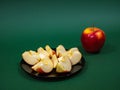 Red yellow apple and slice isolated on green background Royalty Free Stock Photo