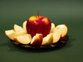 Red yellow apple and slice isolated on green background Royalty Free Stock Photo