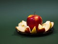 Red yellow apple and slice isolated on green background Royalty Free Stock Photo