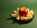 Red yellow apple and slice isolated on green background Royalty Free Stock Photo